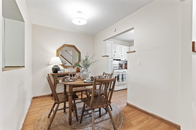 13501 Heather Hills Dr, Burnsville, MN 55337 - dining area with light wood-style flooring and baseboards
