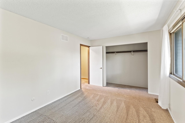 13501 Heather Hills Dr, Burnsville, MN 55337 - unfurnished bedroom featuring carpet floors, a closet, a textured ceiling, and baseboards