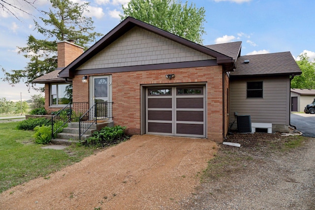 14530 Jonathan Carver Pkwy, Carver, MN 55315 - view of front of home featuring driveway, a chimney, an attached garage, brick siding, and central air condition unit