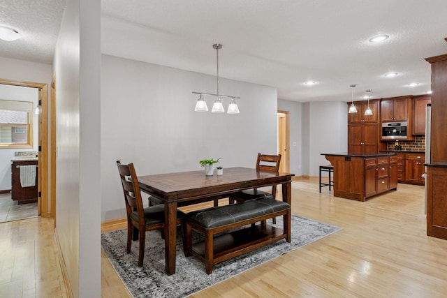 14530 Jonathan Carver Pkwy, Carver, MN 55315 - dining area featuring light wood finished floors, recessed lighting, baseboards, and a textured ceiling