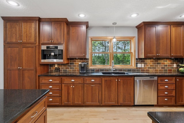 14530 Jonathan Carver Pkwy, Carver, MN 55315 - kitchen with dishwasher, a sink, light wood finished floors, decorative backsplash, and a textured ceiling