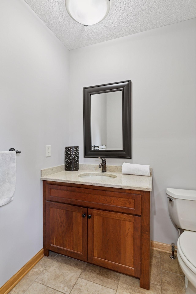 14530 Jonathan Carver Pkwy, Carver, MN 55315 - bathroom with toilet, vanity, baseboards, a textured ceiling, and tile patterned floors