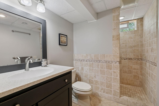 14530 Jonathan Carver Pkwy, Carver, MN 55315 - full bathroom featuring tile walls, vanity, a tile shower, toilet, and a paneled ceiling