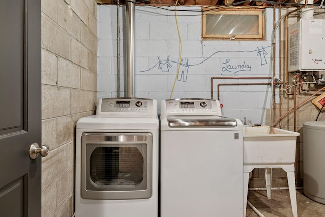 14530 Jonathan Carver Pkwy, Carver, MN 55315 - washroom featuring tankless water heater, concrete block wall, and washing machine and clothes dryer