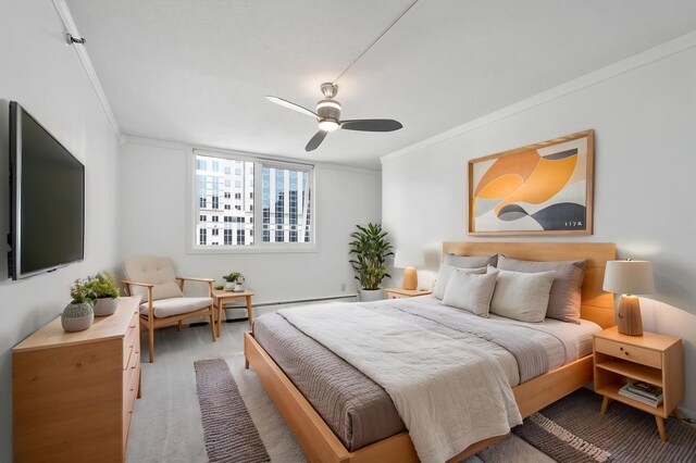 bedroom featuring crown molding, a ceiling fan, a baseboard heating unit, and carpet floors
