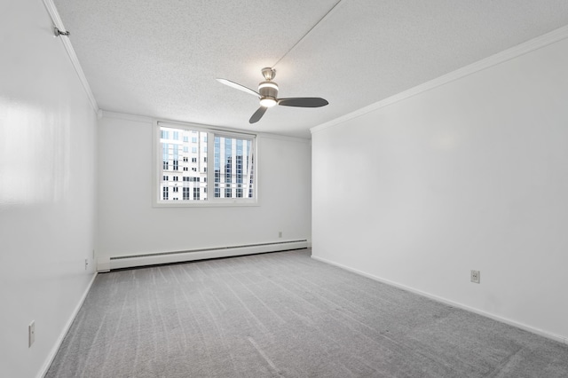 spare room with a baseboard heating unit, ornamental molding, a textured ceiling, ceiling fan, and carpet