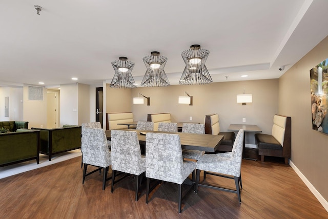 dining room with wood finished floors, baseboards, and recessed lighting
