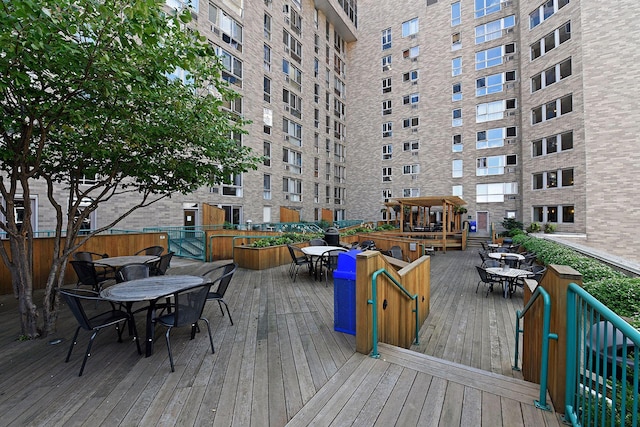 wooden terrace featuring outdoor dining space