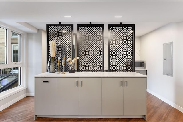 433 7th St Unit 1921, Minneapolis, MN 55415 - detailed view of baseboards, electric panel, and wood finished floors