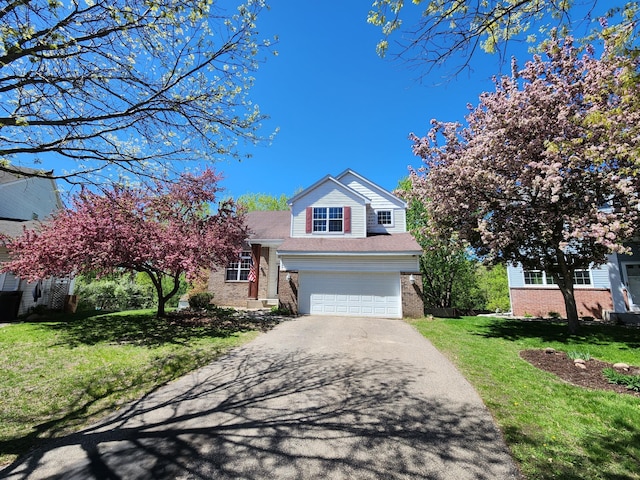 3458 Savannah Ave, White Bear Lake, MN 55110 - traditional home with brick siding, asphalt driveway, a front lawn, and a garage