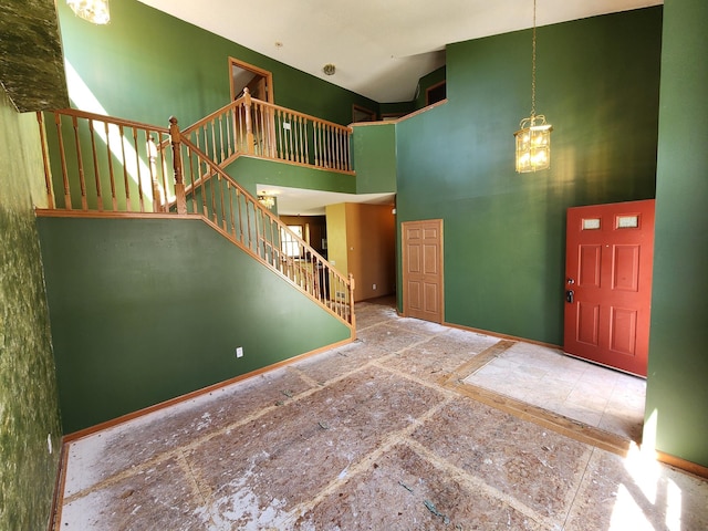 3458 Savannah Ave, White Bear Lake, MN 55110 - foyer entrance featuring a towering ceiling, stairs, baseboards, and a chandelier