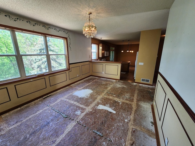 3458 Savannah Ave, White Bear Lake, MN 55110 - unfurnished dining area with a chandelier and a textured ceiling