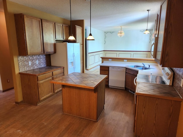 3458 Savannah Ave, White Bear Lake, MN 55110 - kitchen featuring white appliances, tile counters, a sink, dark wood-style floors, and wainscoting