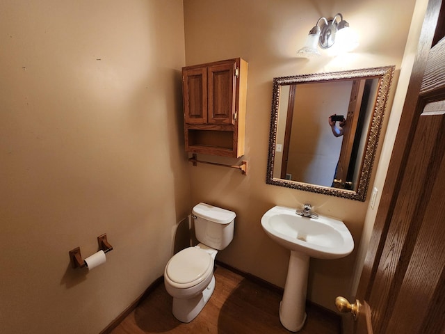 3458 Savannah Ave, White Bear Lake, MN 55110 - bathroom featuring toilet, baseboards, and wood finished floors