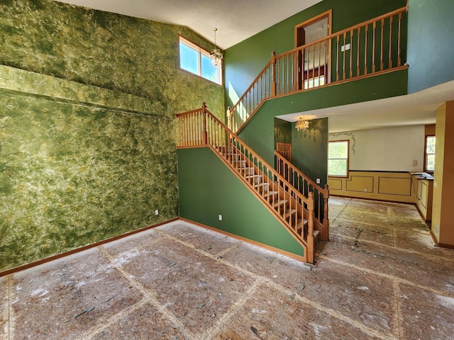 3458 Savannah Ave, White Bear Lake, MN 55110 - unfurnished living room featuring a high ceiling, stairs, and plenty of natural light