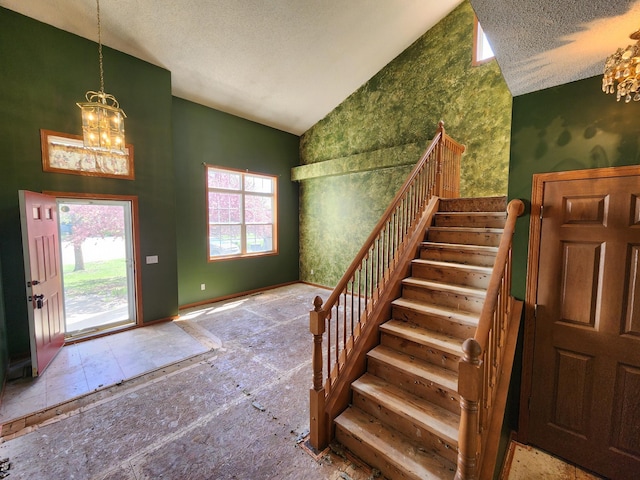 3458 Savannah Ave, White Bear Lake, MN 55110 - entryway featuring a chandelier, stairs, baseboards, a textured ceiling, and high vaulted ceiling