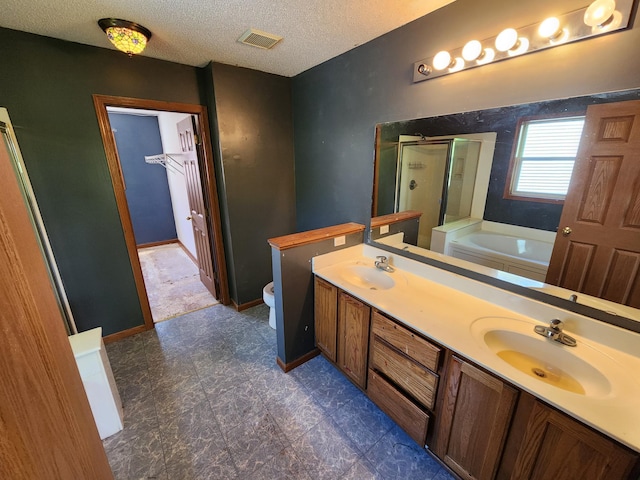3458 Savannah Ave, White Bear Lake, MN 55110 - bathroom with a shower stall, toilet, a bath, double vanity, and a textured ceiling