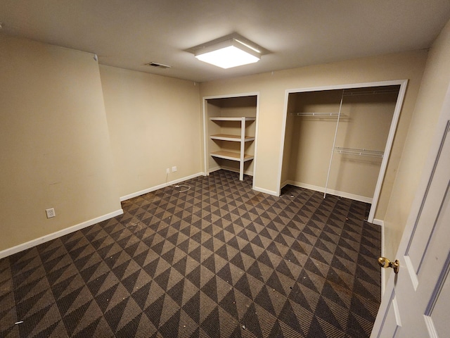3458 Savannah Ave, White Bear Lake, MN 55110 - unfurnished bedroom with multiple closets, baseboards, and dark carpet