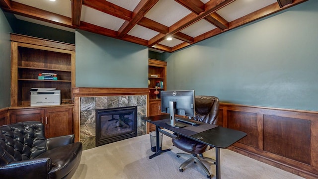 carpeted office featuring coffered ceiling, a premium fireplace, and beamed ceiling