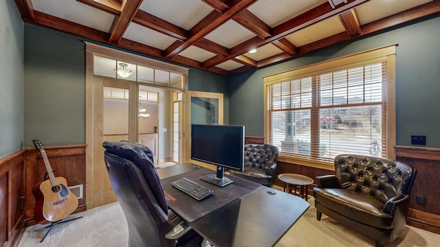 carpeted home office featuring a wainscoted wall, beamed ceiling, and coffered ceiling