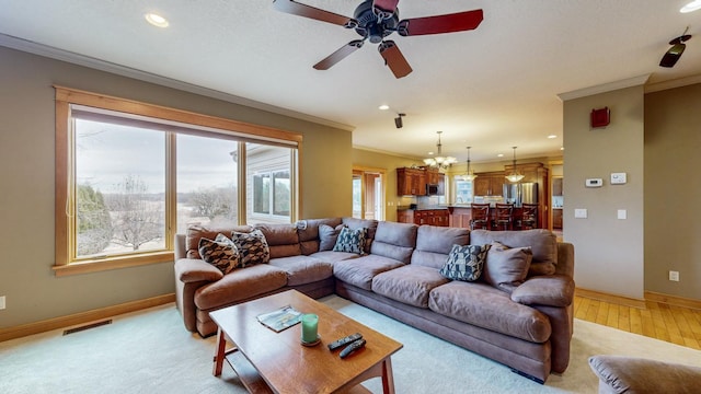 living room featuring ornamental molding, baseboards, ceiling fan, light wood-type flooring, and recessed lighting