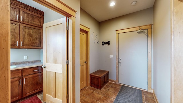 doorway to outside featuring tile patterned flooring
