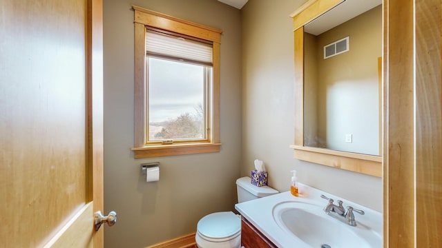 half bath featuring toilet and vanity