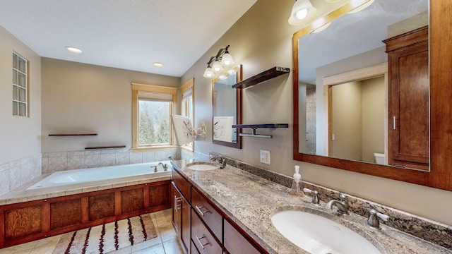 bathroom with tile patterned flooring, a garden tub, toilet, double vanity, and recessed lighting