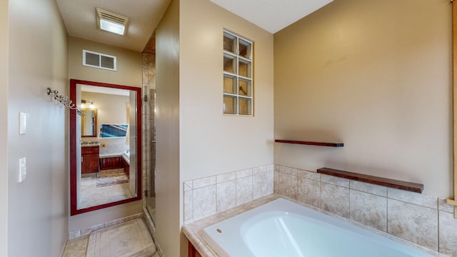 full bath with a bath, baseboards, and a stall shower