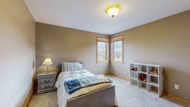carpeted bedroom featuring baseboards