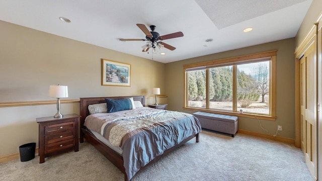 bedroom with light carpet, baseboards, recessed lighting, a ceiling fan, and a closet