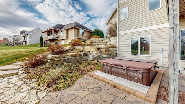 view of yard with a hot tub and a residential view