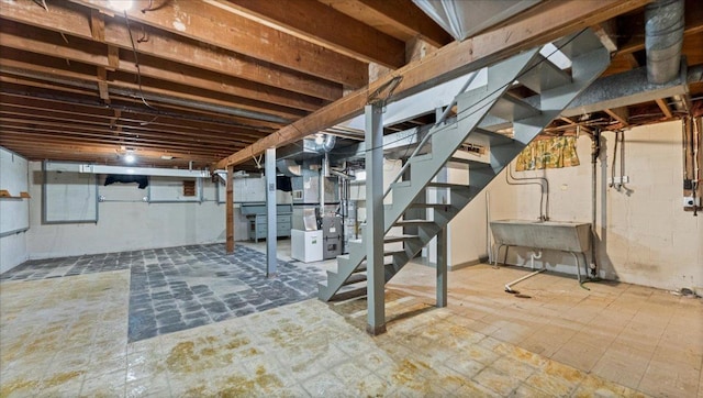 unfinished below grade area with stairway, heating unit, and a sink
