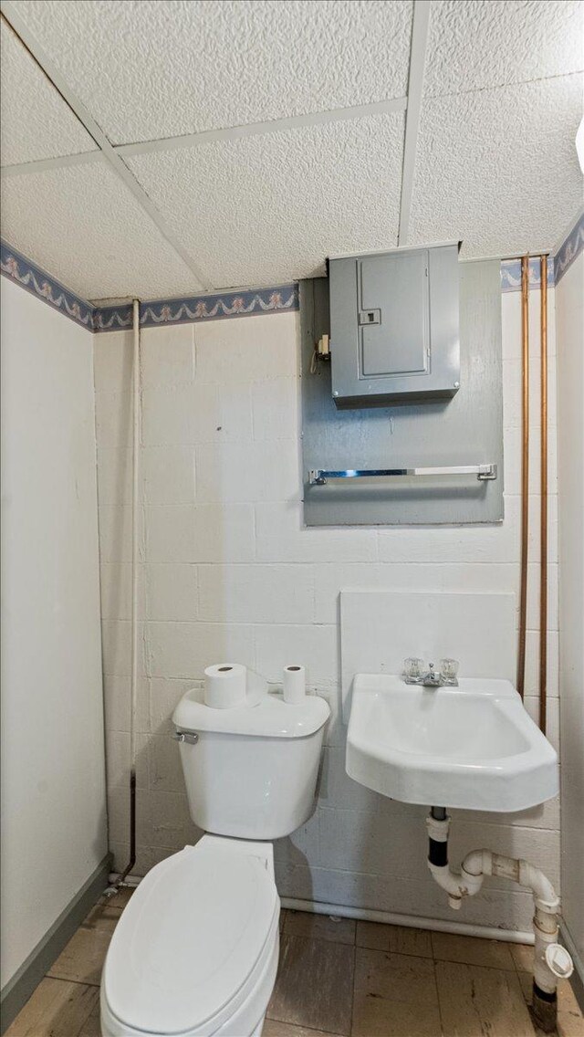 half bathroom featuring a sink and toilet
