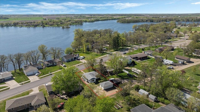 aerial perspective of suburban area featuring a large body of water and property boundaries highlighted