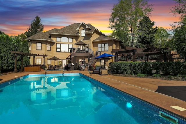 2255 Chelmsford Ln, Saint Cloud, MN 56301 - pool at dusk with a hot tub, a pergola, stairs, and an outdoor pool