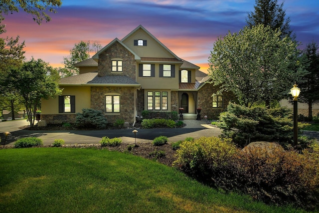 2255 Chelmsford Ln, Saint Cloud, MN 56301 - traditional-style house featuring stone siding, a front lawn, a standing seam roof, stucco siding, and a shingled roof