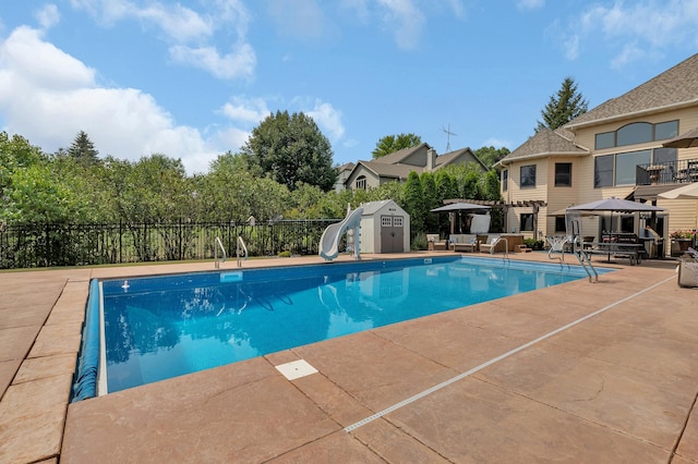 2255 Chelmsford Ln, Saint Cloud, MN 56301 - view of swimming pool featuring a patio area, a water slide, and a gazebo