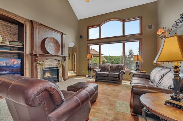 2255 Chelmsford Ln, Saint Cloud, MN 56301 - living area with high vaulted ceiling, a brick fireplace, healthy amount of natural light, light carpet, and arched walkways