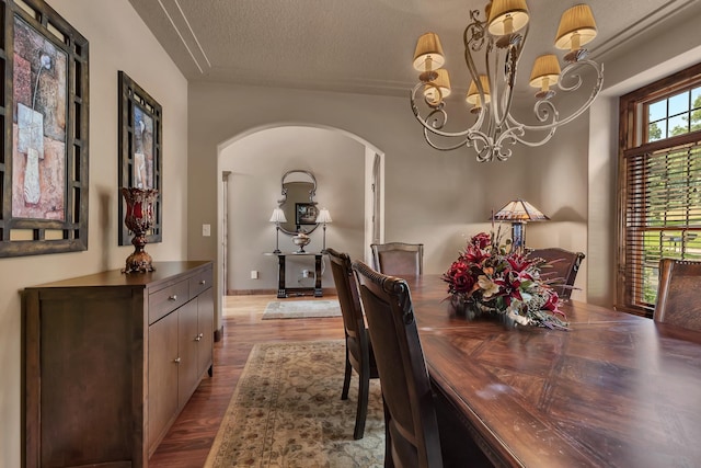 2255 Chelmsford Ln, Saint Cloud, MN 56301 - dining space featuring arched walkways, wood finished floors, a chandelier, and a textured ceiling