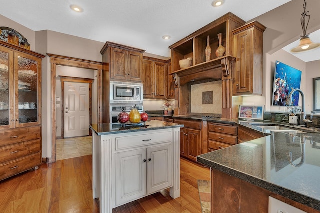 2255 Chelmsford Ln, Saint Cloud, MN 56301 - kitchen with a sink, stainless steel appliances, open shelves, light wood-style flooring, and pendant lighting