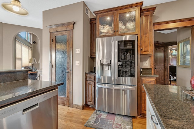 2255 Chelmsford Ln, Saint Cloud, MN 56301 - kitchen with appliances with stainless steel finishes, light wood-style floors, dark stone countertops, and brown cabinetry