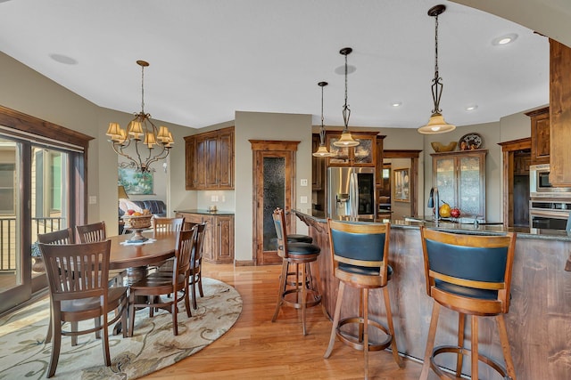 2255 Chelmsford Ln, Saint Cloud, MN 56301 - dining space with light wood-style flooring, recessed lighting, and a chandelier