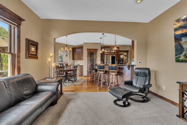 2255 Chelmsford Ln, Saint Cloud, MN 56301 - living room featuring arched walkways, a chandelier, baseboards, light wood-style floors, and recessed lighting