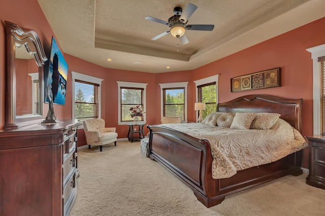 2255 Chelmsford Ln, Saint Cloud, MN 56301 - bedroom featuring light carpet, multiple windows, a raised ceiling, recessed lighting, and a textured ceiling