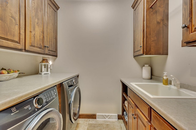 2255 Chelmsford Ln, Saint Cloud, MN 56301 - laundry area featuring washer and clothes dryer, cabinet space, and baseboards