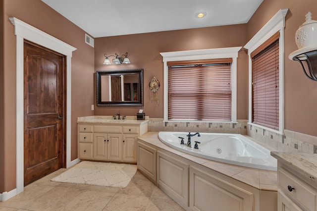 2255 Chelmsford Ln, Saint Cloud, MN 56301 - full bath with a tub with jets, vanity, and tile patterned floors