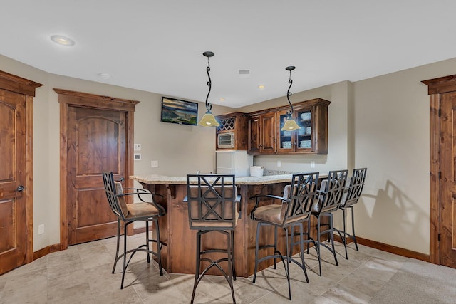 2255 Chelmsford Ln, Saint Cloud, MN 56301 - indoor wet bar with baseboards, hanging light fixtures, and recessed lighting