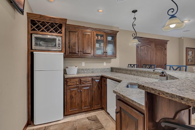 2255 Chelmsford Ln, Saint Cloud, MN 56301 - kitchen featuring a sink, dishwasher, light stone countertops, hanging light fixtures, and stone tile flooring
