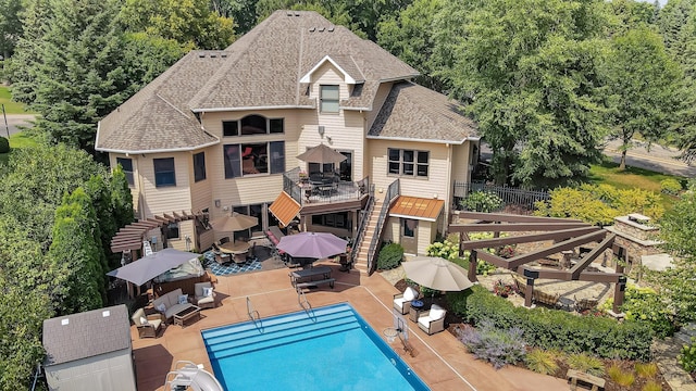 2255 Chelmsford Ln, Saint Cloud, MN 56301 - back of house with outdoor dining area, stairs, roof with shingles, a patio, and an outdoor hangout area